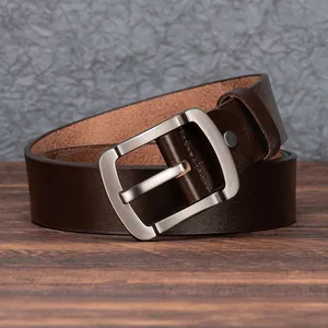 Premium dark brown leather belt with classic silver metal buckle on wooden background