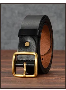 Close-up of a vintage men's black leather belt with a rustic brass square pin buckle