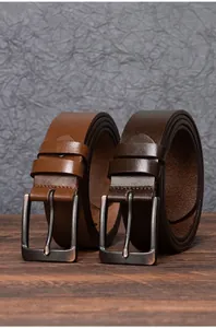 Detail of vintage leather belts in light brown and dark coffee with antique metal buckles