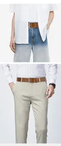 Close-up of brown leather men's belt with silver pin buckle styled with casual trousers