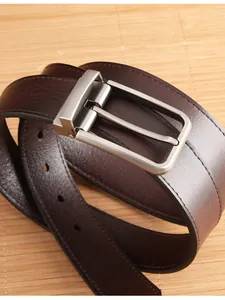 Macro detail of dark brown leather belt with silver brushed pin buckle and stitching