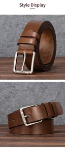 Detail of dark brown leather belt featuring a matte brushed metal pin buckle with grooves