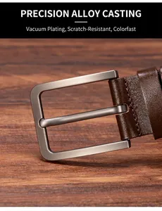 Detail of alloy pin buckle with brushed texture and brown leather strap stitching