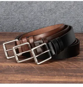 Close-up of retro leather belts in black and brown with textured silver metal buckles