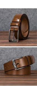 Detail view of brown leather belt with vintage brushed metal buckle and two belt loops