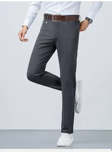 Detailed view of men's dark grey slim fit trousers with subtle micro-plaid texture