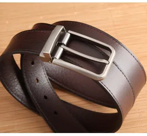 Close-up of deep brown leather belt with matte silver buckle and fine edge stitching