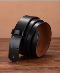 Macro detail of 3.5cm wide vintage black leather belt strap with brown inner lining