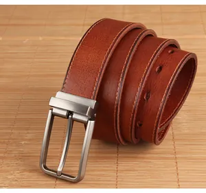 Detailed view of reddish-brown leather belt with vintage texture and fine stitching