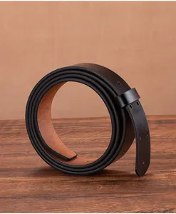 Detail of genuine vintage leather belt strap showing black exterior and tan inner lining
