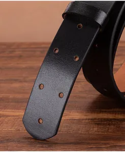 Detail of black leather belt end featuring round punched holes and a matching keeper loop