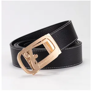 Macro detail of black litchi leather belt with white stitching and gold automatic buckle