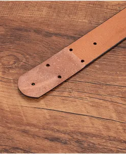 Detail of vintage brown leather belt end with five holes and black edge finish