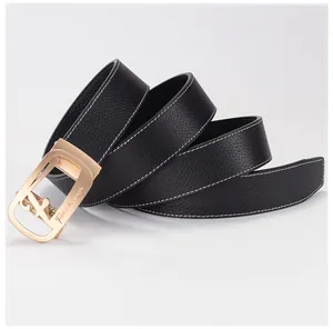 Detail of black pebbled leather belt with white stitching and gold automatic buckle