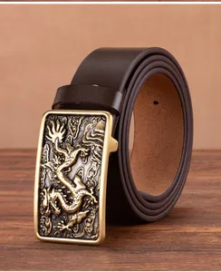 Detail of vintage brown cowhide leather belt with embossed dragon alloy buckle texture