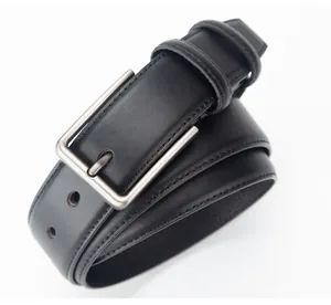 Detail view of the black leather belt with a silver brushed metal rectangular buckle