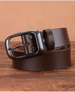 Detailed close-up of vintage brown leather belt with matte gunmetal needle buckle and texture