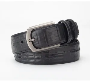 Detail of premium black alligator embossed leather belt with brushed silver buckle