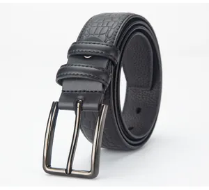 Detail of men's leather belt with crocodile embossing and polished metal needle buckle