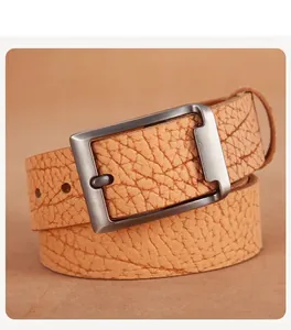 Detail view of ginger brown genuine leather belt with matte brushed metal pin buckle