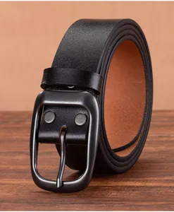 Detailed texture of black top-grain leather belt with a matte grey metal pin buckle