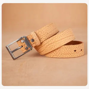 Macro detail of men's genuine leather belt with bison grain texture and matte pin buckle