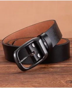 Detailed view of matte gray buckle with rivets on genuine black leather belt strap