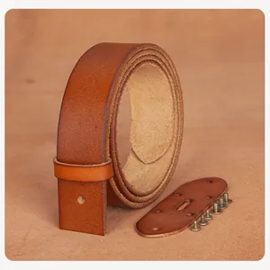 Macro detail of brown top-grain leather DIY belt strap with brass screws and leather patch