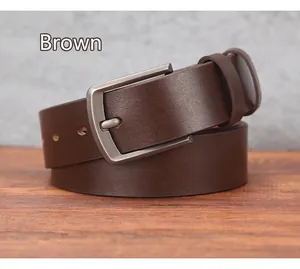 Detail of coffee leather belt with brushed dark gray metal pin buckle texture