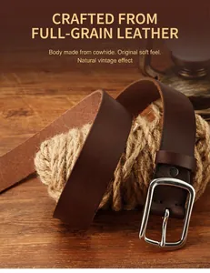 Detail of genuine deep brown leather belt with solid silver metal buckle on rustic background