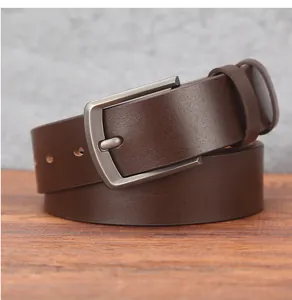 Close-up of dark brown leather belt with matte silver pin buckle on wooden surface