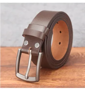 Detail of genuine brown leather belt showing fine grain texture and vintage pin buckle