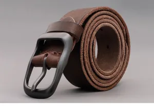 Macro view of dark brown genuine leather belt texture and matte gray pin buckle