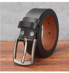 Detailed macro shot of vintage leather belt with silver metal pin buckle and matte finish