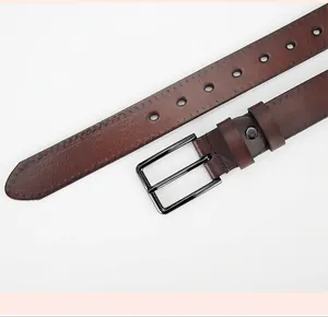 Close-up of brown genuine leather belt with metallic pin buckle and detailed stitching
