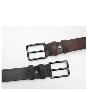Detail of vintage men's leather belts showing alloy pin buckles and textured leather