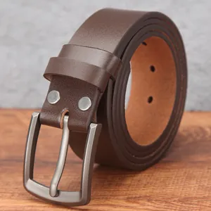 Men's brown genuine leather belt with dark gunmetal pin buckle on wood background