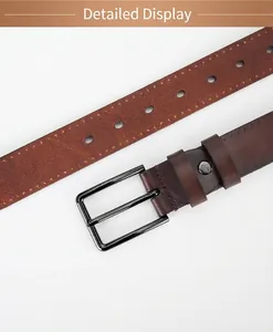 Detail of genuine brown leather belt showing vintage alloy pin buckle and stitching