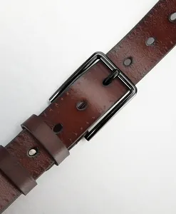 Detail of dark brown leather belt with black metal pin buckle and textured holes