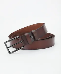 Detailed close-up of brown leather belt with gunmetal alloy pin buckle and fine stitching