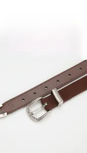 Detail of dark brown cowhide leather belt featuring a carved silver metal pin buckle