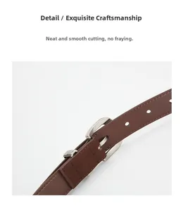Close-up of brown leather belt with matte silver buckle and precision edge stitching