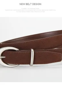 Macro shot of brown frosted leather belt with a silver oval metal buckle and smooth edges