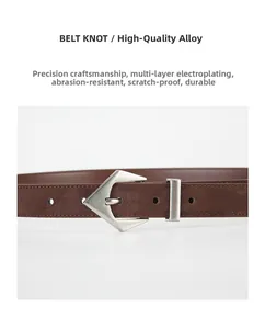 Detailed view of silver alloy buckle with brushed finish on dark brown suede leather belt