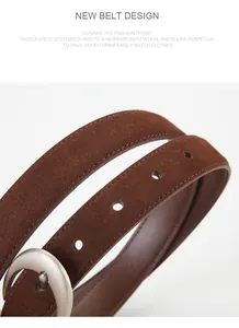Detail shot of brown frosted leather belt with silver metal buckle and precision stitching