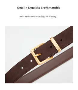 Detailed close-up of brown suede leather belt with matte gold buckle and smooth edges