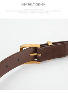 Close-up of vintage brown leather belt with matte gold buckle and detailed stitching