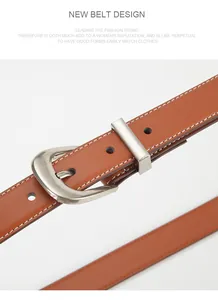 Macro shot of brown leather belt with silver buckle and white decorative stitching