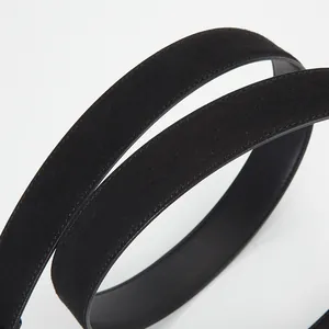 Minimalist black leather belt with matte suede texture and precise tonal stitching detail