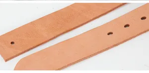 Detailed close-up of premium brown leather belt with natural texture and adjustment holes
